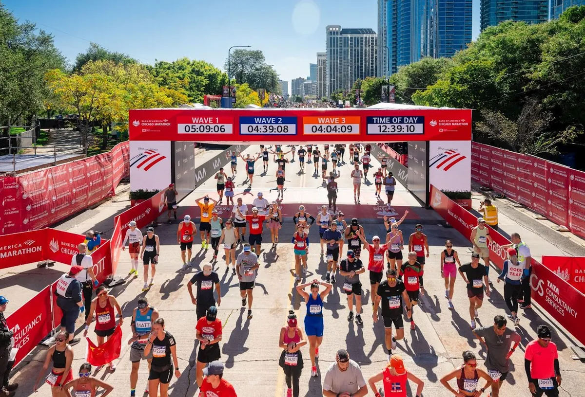 Runners crossing the Bank of America Chicago Marathon finish line in Grant Park
