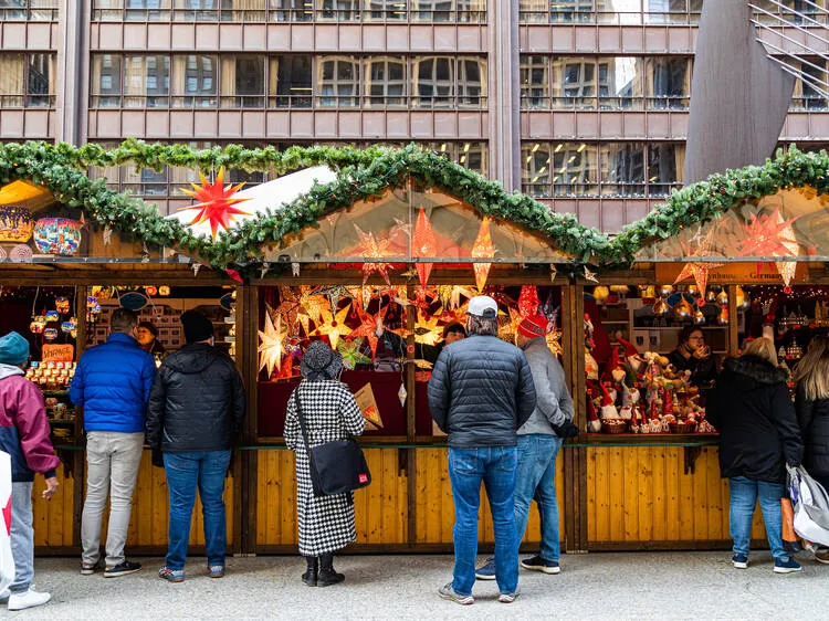 Holiday shoppers at the wooden stalls of Christkindlmarket in Daley Plaza, Chicago