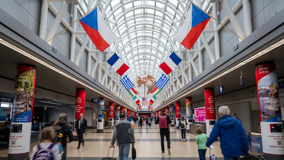 Travelers walking through the arrivals area at O'Hare International Airport